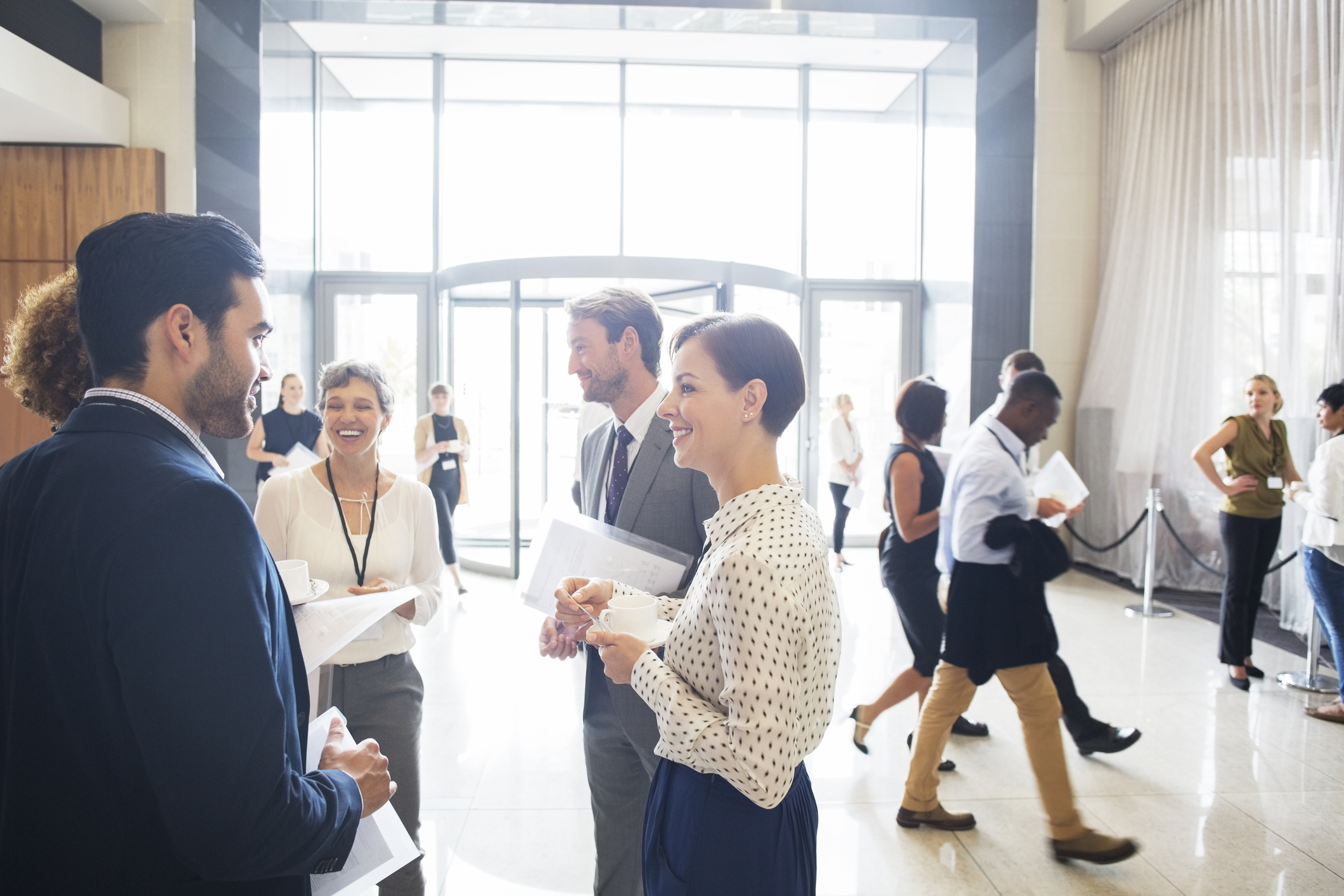 Group of business people standing and talking in office